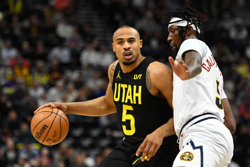 SALT LAKE CITY, UTAH - APRIL 09: Talen Horton-Tucker #5 of the Utah Jazz posts up against Kentavious Caldwell-Pope #5 of the Denver Nuggets in the first half at Delta Center on April 09, 2024 in Salt Lake City, Utah. NOTE TO USER: User expressly acknowledges and agrees that, by downloading and or using this photograph, User is consenting to the terms and conditions of the Getty Images License Agreement.  (Photo by Alex Goodlett/Getty Images)