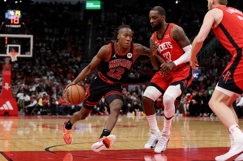 HOUSTON, TEXAS - MARCH 21: Ayo Dosunmu #12 of the Chicago Bulls drives to the basket against Jeff Green #32 of the Houston Rockets in the second half at Toyota Center on March 21, 2024 in Houston, Texas.  NOTE TO USER: User expressly acknowledges and agrees that, by downloading and or using this photograph, User is consenting to the terms and conditions of the Getty Images License Agreement. (Photo by Tim Warner/Getty Images)