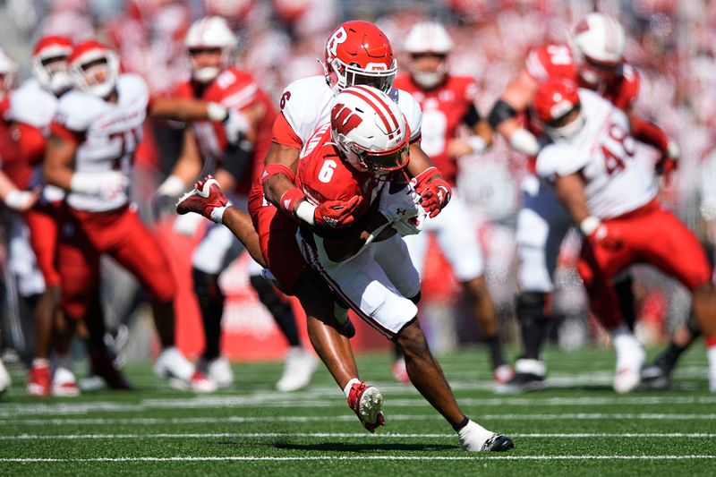 Oct 7, 2023; Madison, Wisconsin, USA;  Wisconsin Badgers wide receiver Will Pauling (6) is tackled by Rutgers Scarlet Knights defensive back Shaquan Loyal (6) during the second quarter at Camp Randall Stadium. Mandatory Credit: Jeff Hanisch-USA TODAY Sports