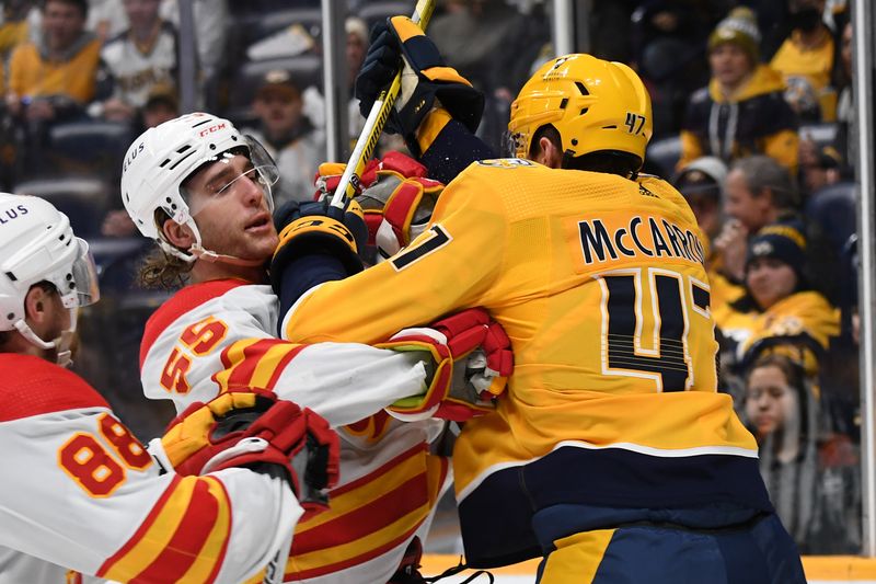 Jan 4, 2024; Nashville, Tennessee, USA; Nashville Predators right wing Michael McCarron (47) and Calgary Flames defenseman Noah Hanifin (55) have to be separated after the whistle during the third period at Bridgestone Arena. Mandatory Credit: Christopher Hanewinckel-USA TODAY Sports