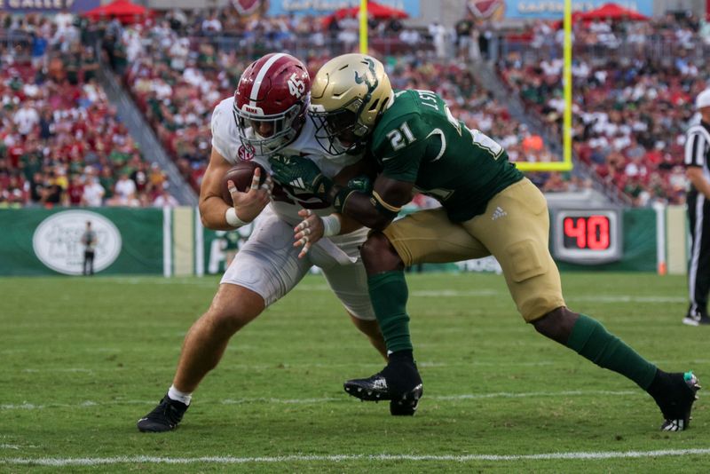 Sep 16, 2023; Tampa, Florida, USA;  South Florida Bulls defensive back Jaelen Stokes (21) stops Alabama Crimson Tide tight end Robbie Ouzts (45) from scoring a touchdown in the third quarter at Raymond James Stadium. Mandatory Credit: Nathan Ray Seebeck-USA TODAY Sports