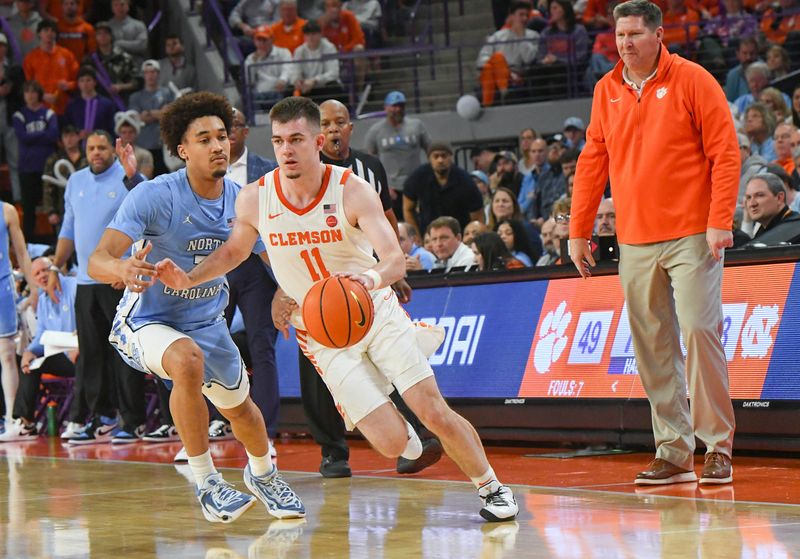 Jan 6, 2024; Clemson, South Carolina, USA; Clemson graduate Joseph Girard III  dribbles near University of North Carolina guard Seth Trimble (7) during the second half at Littlejohn Coliseum. Mandatory Credit: Ken Ruinard-USA TODAY Sports