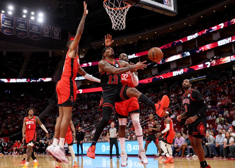 HOUSTON, TEXAS - MARCH 21: Torrey Craig #13 of the Chicago Bulls goes up for a lay up against Jeff Green #32 of the Houston Rockets and Jabari Smith Jr. #10 in the second half at Toyota Center on March 21, 2024 in Houston, Texas.  NOTE TO USER: User expressly acknowledges and agrees that, by downloading and or using this photograph, User is consenting to the terms and conditions of the Getty Images License Agreement. (Photo by Tim Warner/Getty Images)