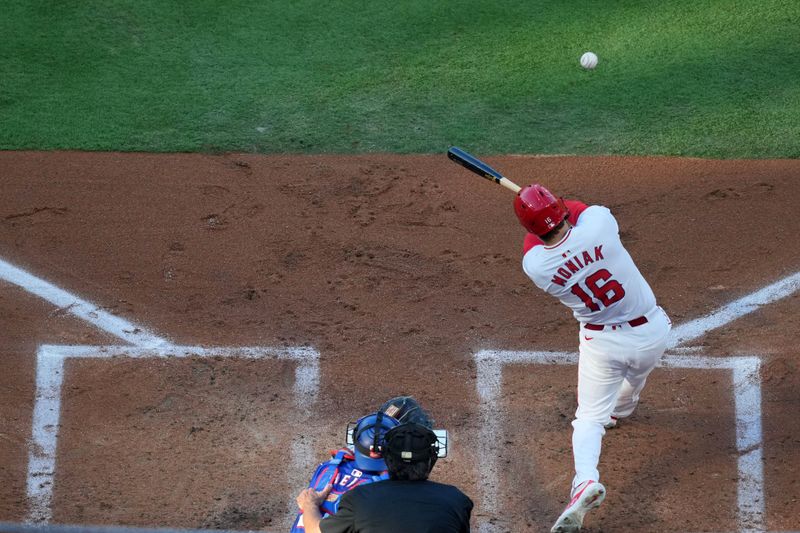 May 6, 2023; Anaheim, California, USA;  Los Angeles Angels center fielder Mickey Moniak (16) hits a two-run triple in the first inning as Texas Rangers catcher Jonah Heim (28) watches at Angel Stadium. Mandatory Credit: Kirby Lee-USA TODAY Sports
