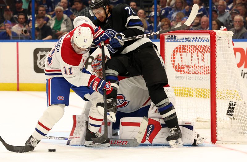 Mar 2, 2024; Tampa, Florida, USA;  Montreal Canadiens right wing Brendan Gallagher (11) and goaltender Cayden Primeau (30) defends Tampa Bay Lightning center Anthony Cirelli (71) during the first period at Amalie Arena. Mandatory Credit: Kim Klement Neitzel-USA TODAY Sports