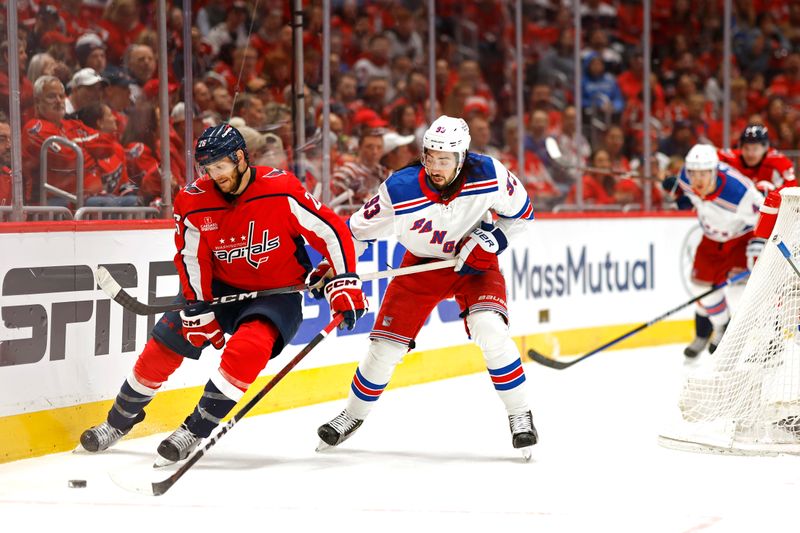 Apr 26, 2024; Washington, District of Columbia, USA;Washington Capitals center Nic Dowd (26) and New York Rangers center Mika Zibanejad (93) battle for the puck in the third period in game three of the first round of the 2024 Stanley Cup Playoffs at Capital One Arena. Mandatory Credit: Geoff Burke-USA TODAY Sports