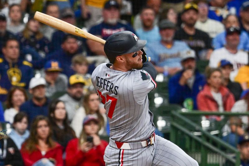 May 17, 2025; Milwaukee, Wisconsin, USA;  Minnesota Twins designated hitter Ryan Jeffers (27) hits a double in the third inning against the Milwaukee Brewers at American Family Field. Mandatory Credit: Benny Sieu-Imagn Images