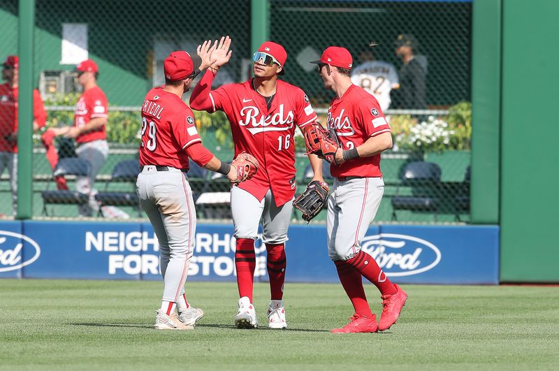 Aug 10, 2025; Pittsburgh, Pennsylvania, USA;  Cincinnati Reds center fielder outfielder TJ Friedl (29) and right fielder Noelvi Marte (16) and left fielder Austin Hays (right) celebrate in the outfield after defeating the Pittsburgh Pirates at PNC Park. Mandatory Credit: Charles LeClaire-Imagn Images