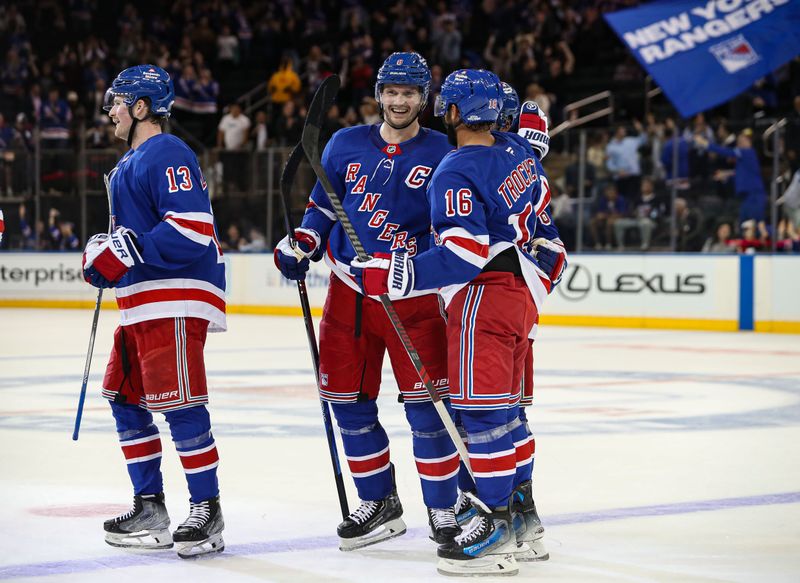 Sep 24, 2024; New York, New York, USA; New York Rangers defenseman Jacob Trouba (8) celebrates a goal with center Vincent Trocheck (16) and left wing Alexis Lafreniere (13) during the third period against the New York Islanders at Madison Square Garden. Mandatory Credit: Danny Wild-Imagn Images