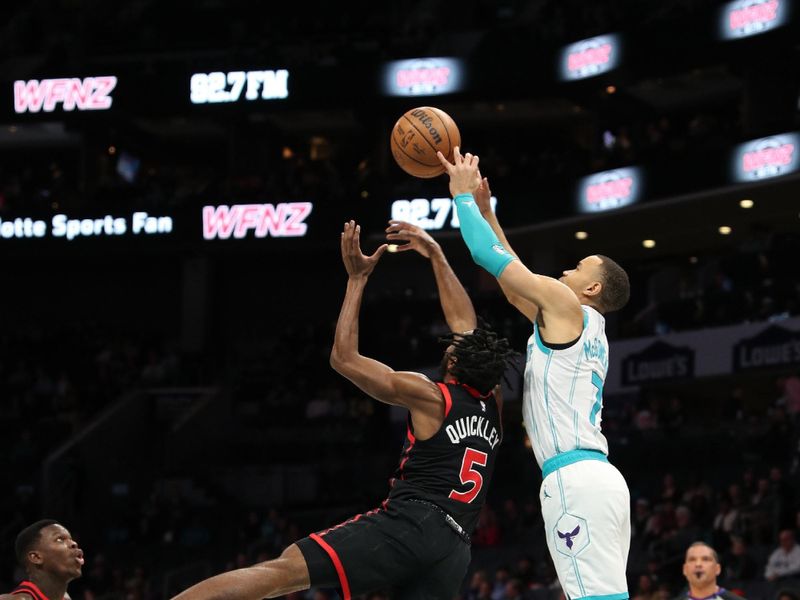 CHARLOTTE, NC - FEBRUARY 7:  Bryce McGowans #7 of the Charlotte Hornets and Immanuel Quickley #5 of the Toronto Raptors battle for a rebound on February 7, 2024 at Spectrum Center in Charlotte, North Carolina. NOTE TO USER: User expressly acknowledges and agrees that, by downloading and or using this photograph, User is consenting to the terms and conditions of the Getty Images License Agreement.  Mandatory Copyright Notice:  Copyright 2024 NBAE (Photo by Brock Williams-Smith/NBAE via Getty Images)