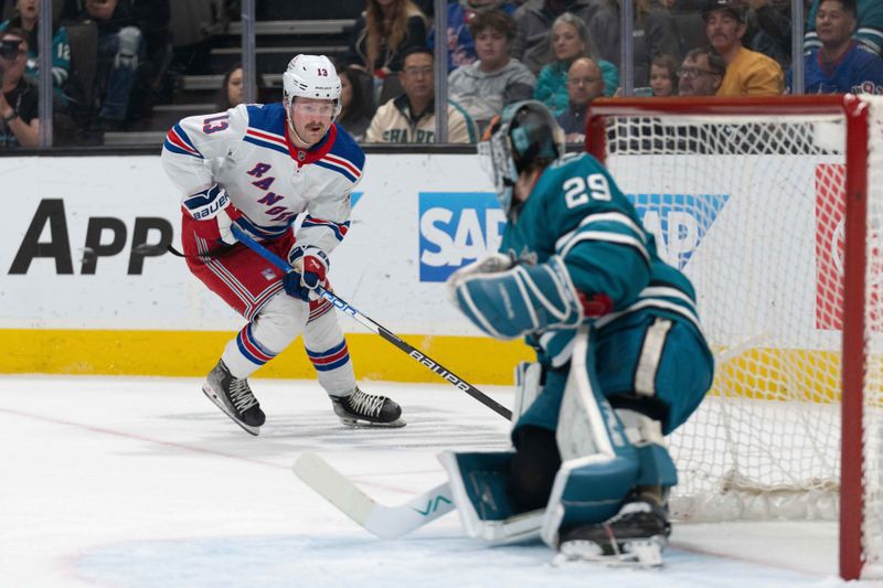 Jan 23, 2024; San Jose, California, USA; New York Rangers left wing Alexis Lafreniere (13) controls the puck during the first period against San Jose Sharks goaltender Mackenzie Blackwood (29) at SAP Center at San Jose. Mandatory Credit: Stan Szeto-USA TODAY Sports