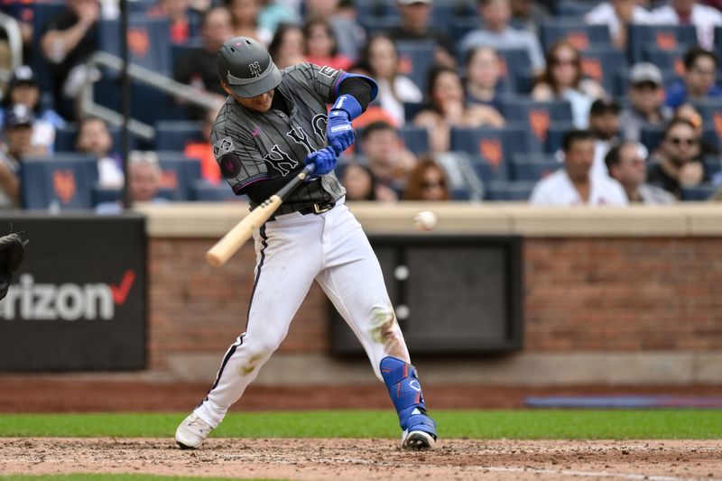 Jun 29, 2024; New York City, New York, USA; New York Mets second baseman Jose Iglesias (11) hits a double against the Houston Astros during the fifth inning at Citi Field. Mandatory Credit: John Jones-USA TODAY Sports