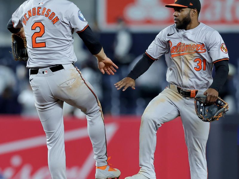 Sep 25, 2024; Bronx, New York, USA; Baltimore Orioles shortstop Gunnar Henderson (2) and center fielder Cedric Mullins (31) celebrate after defeating the New York Yankees at Yankee Stadium. Mandatory Credit: Brad Penner-Imagn Images