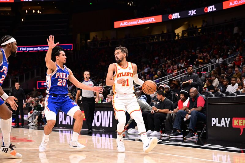 ATLANTA, GA - OCTOBER 14:  Trae Young #11 of the Atlanta Hawks looks to pass the ball during the game against the Philadelphia 76ers during a preseason game on October 14, 2024 at State Farm Arena in Atlanta, Georgia.  NOTE TO USER: User expressly acknowledges and agrees that, by downloading and/or using this Photograph, user is consenting to the terms and conditions of the Getty Images License Agreement. Mandatory Copyright Notice: Copyright 2024 NBAE (Photo by Adam Hagy/NBAE via Getty Images)