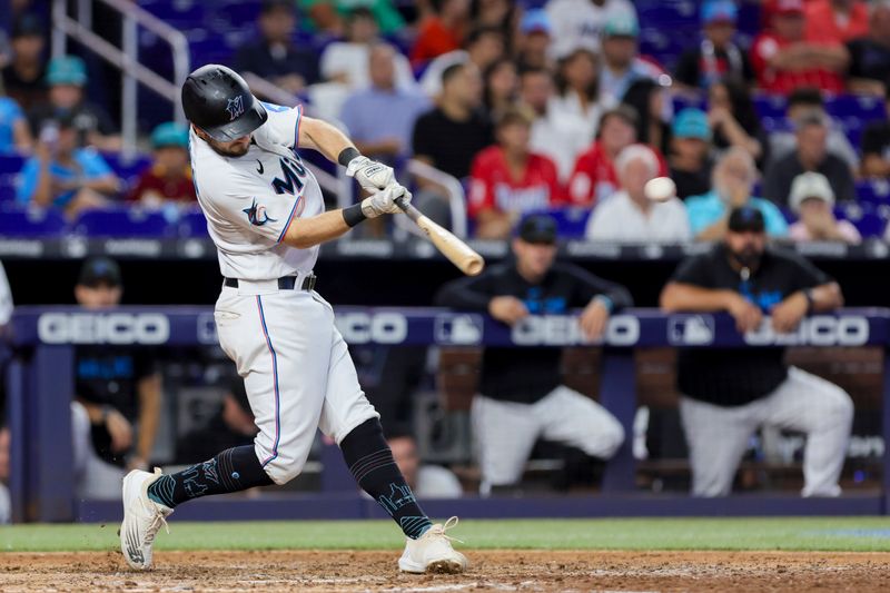 Jul 30, 2023; Miami, Florida, USA; Miami Marlins center fielder Garrett Hampson (1) hits a single against the Detroit Tigers during the eighth inning at loanDepot Park. Mandatory Credit: Sam Navarro-USA TODAY Sports