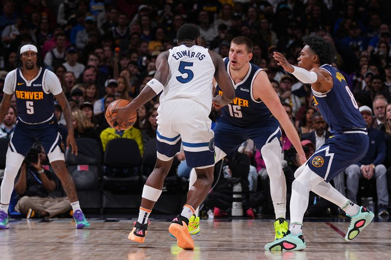 DENVER, CO - APRIL 10: Anthony Edwards #5 of the Minnesota Timberwolves handles the ball against Nikola Jokic #15 of the Denver Nuggets during the game on April 10, 2024 at the Ball Arena in Denver, Colorado. NOTE TO USER: User expressly acknowledges and agrees that, by downloading and/or using this Photograph, user is consenting to the terms and conditions of the Getty Images License Agreement. Mandatory Copyright Notice: Copyright 2024 NBAE (Photo by Bart Young/NBAE via Getty Images)