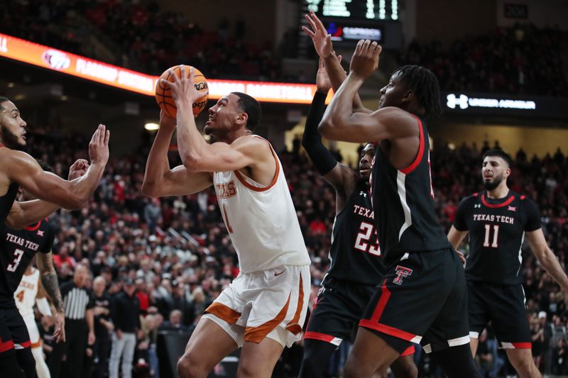 Feb 13, 2023; Lubbock, Texas, USA;  Texas Longhorns forward Dylan Disu (1) takes a shot in front of Texas Tech Red Raiders forward Kevin Obanor (0) in the second half at United Supermarkets Arena. Mandatory Credit: Michael C. Johnson-USA TODAY Sports