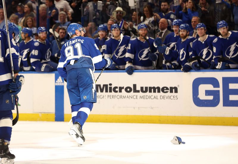 Apr 9, 2024; Tampa, Florida, USA; Tampa Bay Lightning center Steven Stamkos (91) is congratulated after he scored a hat trick and hats are thrown on the ice against the Columbus Blue Jackets during the third period at Amalie Arena. Mandatory Credit: Kim Klement Neitzel-USA TODAY Sports