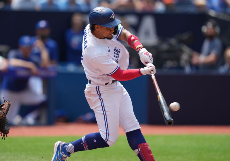 Jul 16, 2023; Toronto, Ontario, CAN; Toronto Blue Jays second baseman Santiago Espinal (5) hits an RBI double against the Arizona Diamondbacks during the second inning at Rogers Centre. Mandatory Credit: Nick Turchiaro-USA TODAY Sports