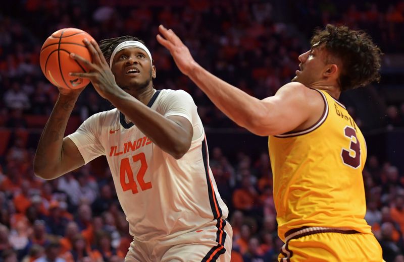 Feb 20, 2023; Champaign, Illinois, USA;  Illinois Fighting Illini forward Dain Dainja (42) moves to the basket as Minnesota Golden Gophers forward Dawson Garcia (3) pressures him during the first half at State Farm Center. Mandatory Credit: Ron Johnson-USA TODAY Sports