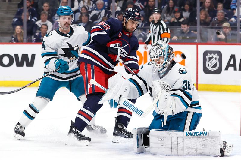 Feb 14, 2024; Winnipeg, Manitoba, CAN; San Jose Sharks defenseman Kyle Burroughs (4) and Winnipeg Jets Nino Neiderreiter (62) watch the  puck pass by San Jose Sharks goaltender Kaapo Kahkonen (36) in the second period at Canada Life Centre. Mandatory Credit: James Carey Lauder-USA TODAY Sports