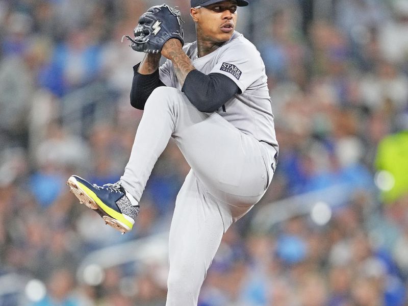 Jun 28, 2024; Toronto, Ontario, CAN; New York Yankees starting pitcher Marcus Stroman (0) throws a pitch against the Toronto Blue Jays during the first inning at Rogers Centre. Mandatory Credit: Nick Turchiaro-USA TODAY Sports