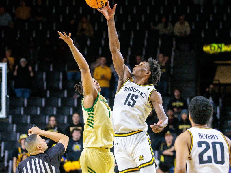 Jan 14, 2025; Wichita, Kansas, USA; Wichita State Shockers center Quincy Ballard (15) gets the tip off to start the game against the Charlotte 49ers at Charles Koch Arena. Mandatory Credit: William Purnell-Imagn Images