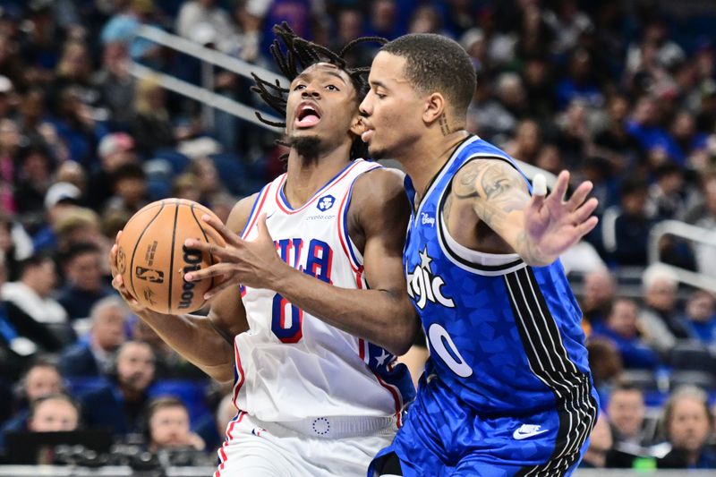 ORLANDO, FLORIDA - JANUARY 19: Tyrese Maxey #0 of the Philadelphia 76ers drives to the net against Markelle Fultz #20 of the Orlando Magic in the first half of a game at Kia Center on January 19, 2024 in Orlando, Florida. NOTE TO USER: User expressly acknowledges and agrees that, by downloading and or using this photograph, User is consenting to the terms and conditions of the Getty Images License Agreement. (Photo by Julio Aguilar/Getty Images)