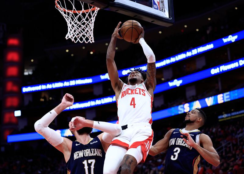 HOUSTON, TEXAS - JANUARY 31: Jalen Green #4 of the Houston Rockets drives to the net ahead of CJ McCollum #3 of the New Orleans Pelicans during the first half at Toyota Center on January 31, 2024 in Houston, Texas. NOTE TO USER: User expressly acknowledges and agrees that, by downloading and or using this photograph, User is consenting to the terms and conditions of the Getty Images License Agreement.? (Photo by Carmen Mandato/Getty Images)