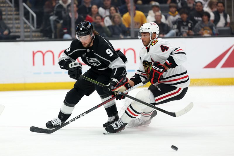 Mar 19, 2024; Los Angeles, California, USA;  Los Angeles Kings right wing Adrian Kempe (9) fights for the puck against Chicago Blackhawks defenseman Seth Jones (4) during the first period at Crypto.com Arena. Mandatory Credit: Kiyoshi Mio-USA TODAY Sports