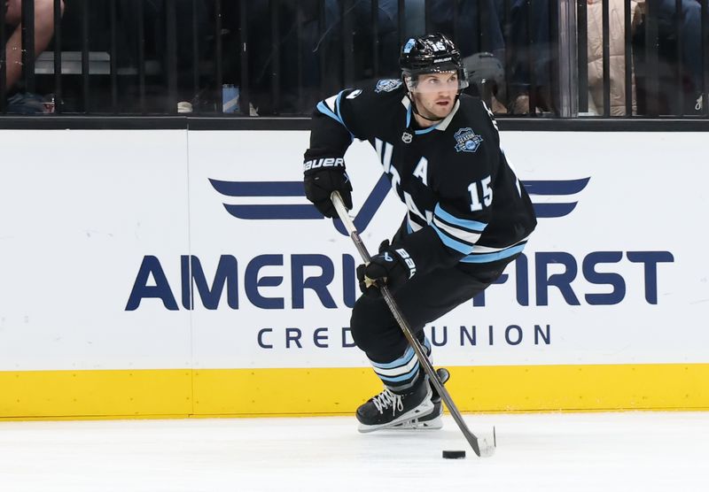 Oct 24, 2024; Salt Lake City, Utah, USA; Utah Hockey Club center Alexander Kerfoot (15) skates with the puck against the Colorado Avalanche during the third period at Delta Center. Mandatory Credit: Rob Gray-Imagn Images