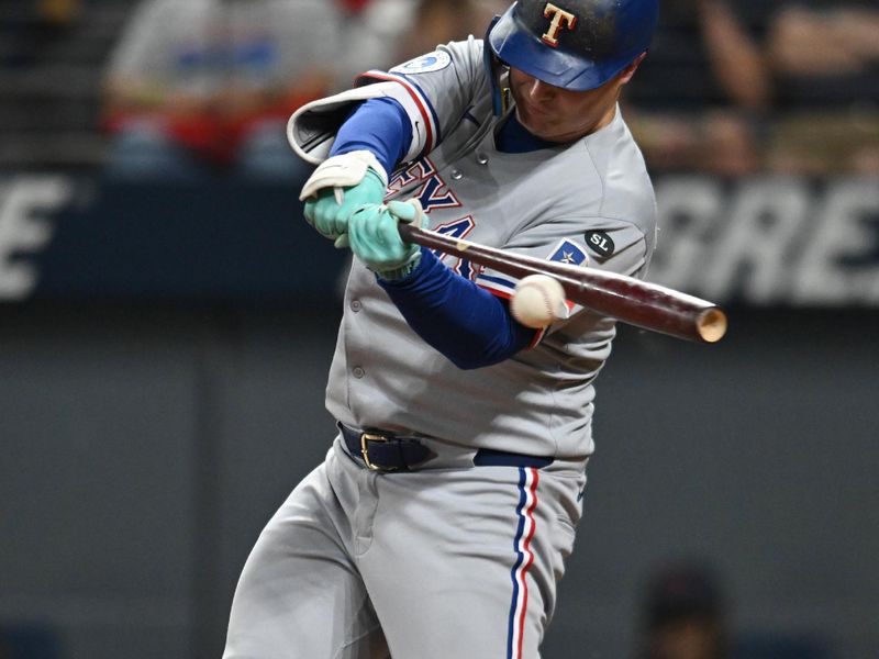 Sep 26, 2025; Cleveland, Ohio, USA; Texas Rangers designated hitter Joc Pederson (4) hits a single against the Cleveland Guardians during the ninth inning at Progressive Field. Mandatory Credit: Ken Blaze-Imagn Images