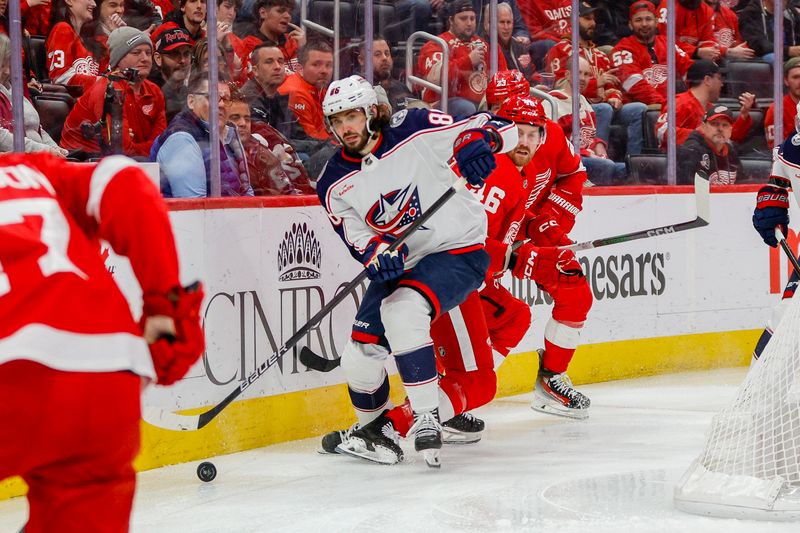 Mar 19, 2024; Detroit, Michigan, USA; Columbus Blue Jackets right wing Kirill Marchenko (86) handles the puck behind the net during the third period of the game against the Detroit Red Wings at Little Caesars Arena. Mandatory Credit: Brian Bradshaw Sevald-USA TODAY Sports