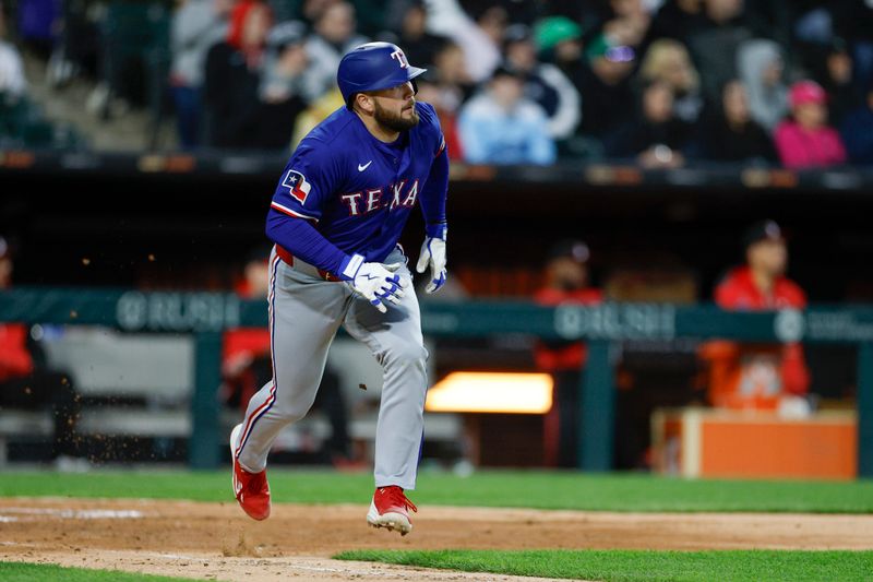 May 23, 2025; Chicago, Illinois, USA; Texas Rangers first baseman Jake Burger (21) runs after hitting an RBI-double against the Chicago White Sox during the sixth inning at Rate Field. Mandatory Credit: Kamil Krzaczynski-Imagn Images