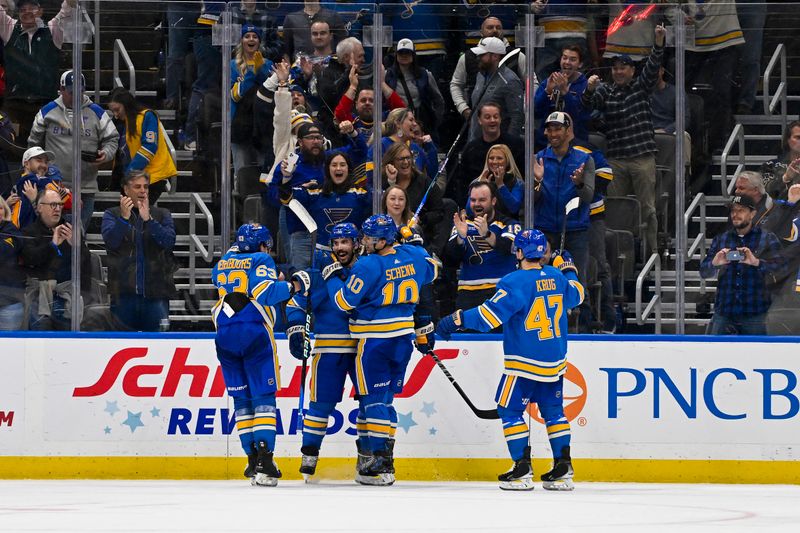 Dec 23, 2023; St. Louis, Missouri, USA;  St. Louis Blues defenseman Justin Faulk (72) is congratulated by teammates after scoring against the Chicago Blackhawks during the third period at Enterprise Center. Mandatory Credit: Jeff Curry-USA TODAY Sports