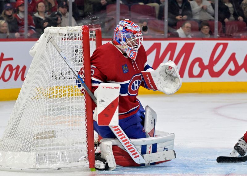 Nov 15, 2025; Montreal, Quebec, CAN; The puck hits the crossbar behind Montreal Canadiens goalie Sam Montembeault (35) during the third period of the game against the Boston Bruins at the Bell Centre. Mandatory Credit: Eric Bolte-Imagn Images