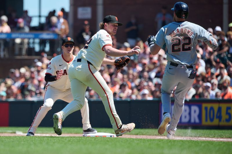 Aug 10, 2024; San Francisco, California, USA; San Francisco Giants starting pitcher Logan Webb (62) tags out Detroit Tigers outfielder Parker Meadows (22) on the first base line as infielder Mark Canha (16) watches the play during the seventh inning at Oracle Park. Mandatory Credit: Robert Edwards-USA TODAY Sports