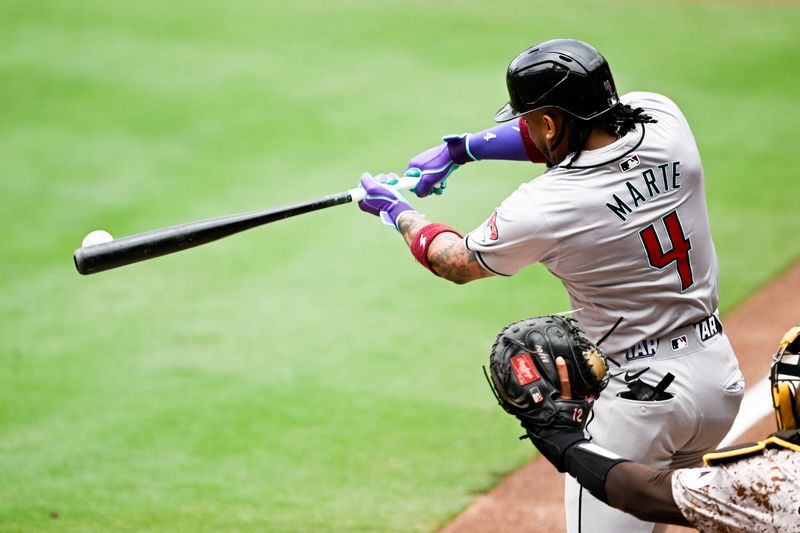 Jun 9, 2024; San Diego, California, USA; Arizona Diamondbacks second baseman Ketel Marte (4) hits a single during the second inning against the San Diego Padres at Petco Park. Mandatory Credit: Denis Poroy-USA TODAY Sports at Petco Park. 