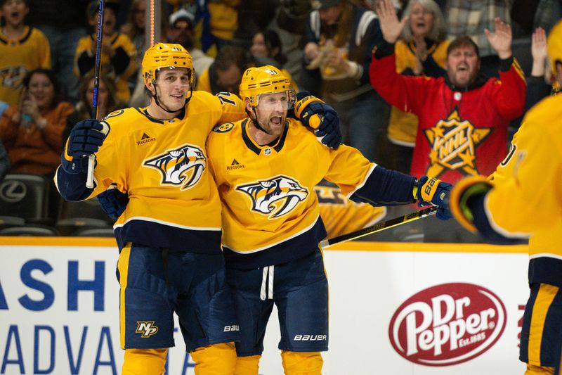 Nov 23, 2024; Nashville, Tennessee, USA;  Nashville Predators center Steven Stamkos (91) celebrates his goal with defenseman Brady Skjei (76) during the third period against the Winnipeg Jets at Bridgestone Arena. Mandatory Credit: Steve Roberts-Imagn Images