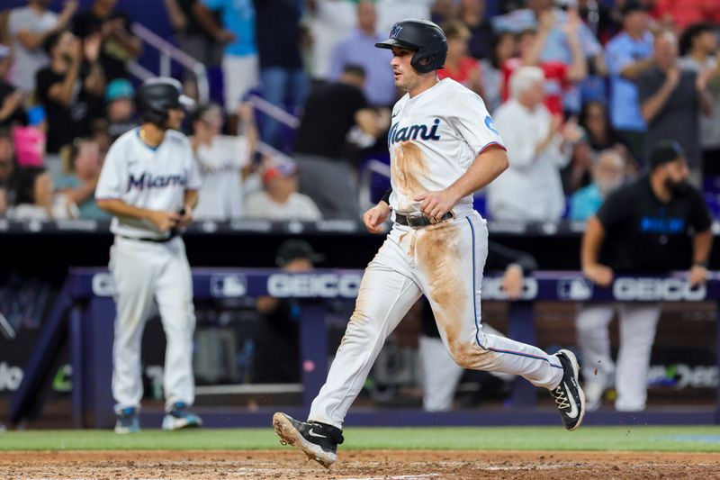 Jul 30, 2023; Miami, Florida, USA; Miami Marlins catcher Nick Fortes (4) scores after a two-run double by center fielder Garrett Hampson (not pictured) during the fifth inning at loanDepot Park. Mandatory Credit: Sam Navarro-USA TODAY Sports