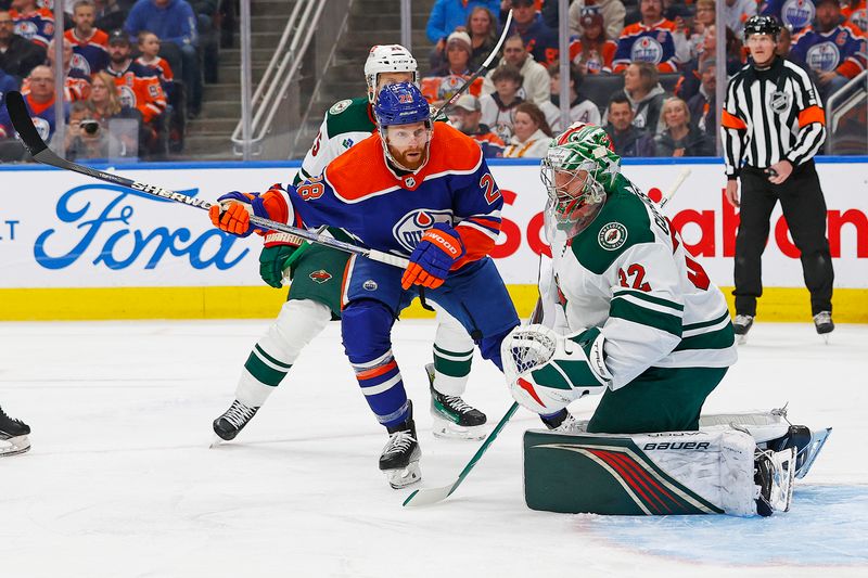 Feb 23, 2024; Edmonton, Alberta, CAN; Edmonton Oilers forward Connor Brown (28) looks for a loose puck in front of Minnesota Wild goaltender Filip Gustavsson (32) during the first period at Rogers Place. Mandatory Credit: Perry Nelson-USA TODAY Sports