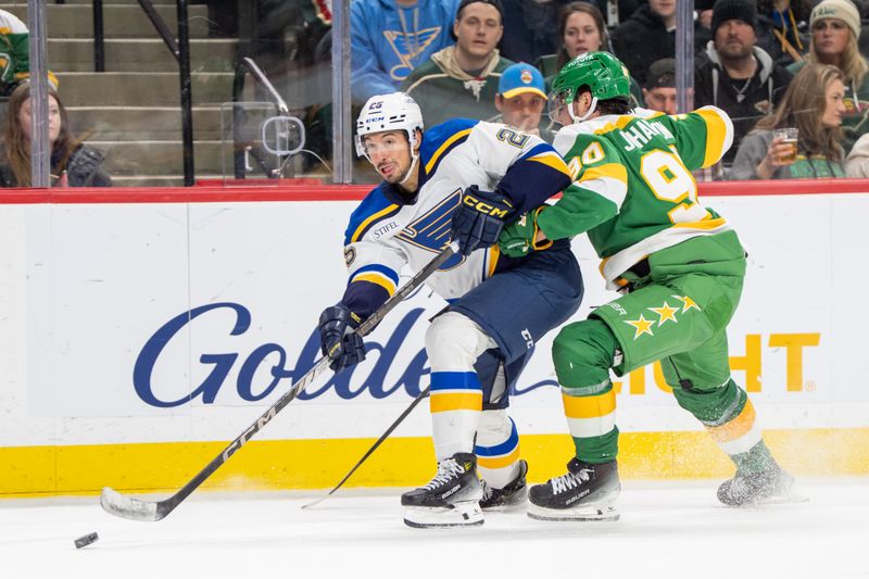 Mar 15, 2025; Saint Paul, Minnesota, USA; St. Louis Blues center Jordan Kyrou (25) is checked by Minnesota Wild left wing Marcus Johansson (90) in the third period at Xcel Energy Center. Mandatory Credit: Matt Blewett-Imagn Images