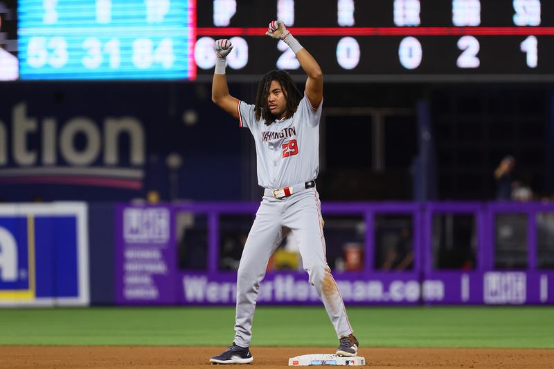 Sep 4, 2024; Miami, Florida, USA; Washington Nationals left fielder James Wood (29) celebrates from second base after hitting a double against the Miami Marlins during the seventh inning at loanDepot Park. Mandatory Credit: Sam Navarro-Imagn Images