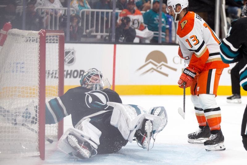 Oct 12, 2024; San Jose, California, USA; San Jose Sharks goaltender Vitek Vanecek (41) tumbles over backward while reaching for a shot on goal as Anaheim Ducks center Robby Fabbri (13) hovers near the net during the second period at SAP Center at San Jose. Mandatory Credit: D. Ross Cameron-Imagn Images