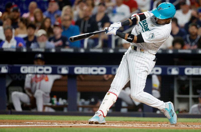 Sep 15, 2023; Miami, Florida, USA; Miami Marlins second baseman Luis Arraez (3) hits a home run against the Atlanta Braves during the first inning at loan Depot Park. Mandatory Credit: Rhona Wise-USA TODAY Sports