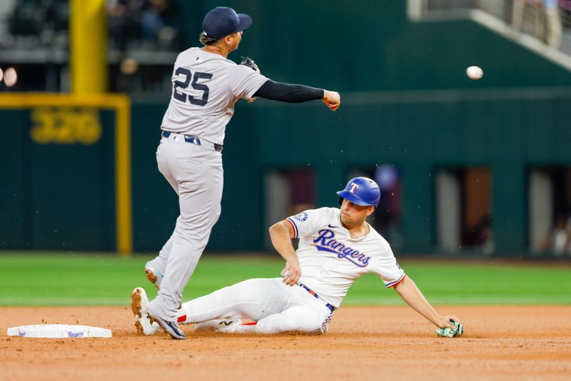 Sep 4, 2024; Arlington, Texas, USA; Texas Rangers first base Nathaniel Lowe (30) is forced out at second base by New York Yankees second base Gleyber Torres (25) during the first inning at Globe Life Field. Mandatory Credit: Andrew Dieb-Imagn Images