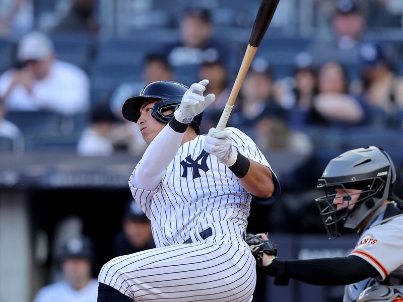 Apr 1, 2023; Bronx, New York, USA; New York Yankees shortstop Anthony Volpe (11) follows through on a single against the San Francisco Giants during the second inning at Yankee Stadium. The hit was hit first major league hit. Mandatory Credit: Brad Penner-USA TODAY Sports