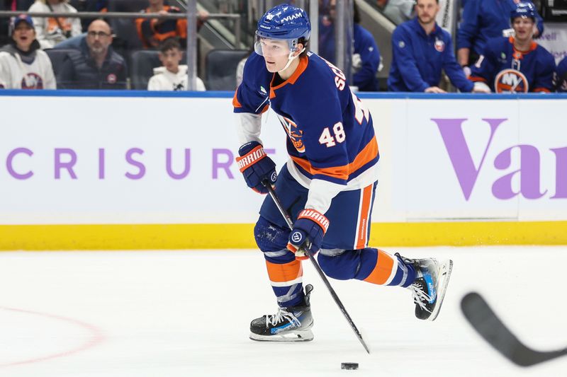 Nov 22, 2025; Elmont, New York, USA; New York Islanders defenseman Matthew Schaefer (48) controls the puck in the second period against the St. Louis Blues at UBS Arena. Mandatory Credit: Wendell Cruz-Imagn Images