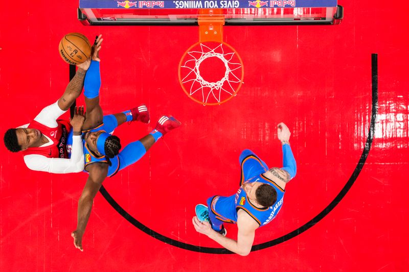 TORONTO, ON - DECEMBER 05: RJ Barrett #9 of the Toronto Raptors drives to the basket against Luguentz Dort #5 of the Oklahoma City Thunder at Scotiabank Arena on December 5, 2024 in Toronto, Ontario, Canada. NOTE TO USER: User expressly acknowledges and agrees that, by downloading and/or using this Photograph, user is consenting to the terms and conditions of the Getty Images License Agreement. (Photo by Andrew Lahodynskyj/Getty Images)