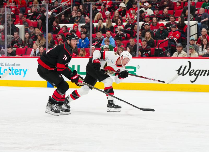 Nov 16, 2024; Raleigh, North Carolina, USA;  aOttawa Senators left wing Brady Tkachuk (7) takes a shot against Carolina Hurricanes defenseman Jaccob Slavin (74) during the second period t Lenovo Center. Mandatory Credit: James Guillory-Imagn Images